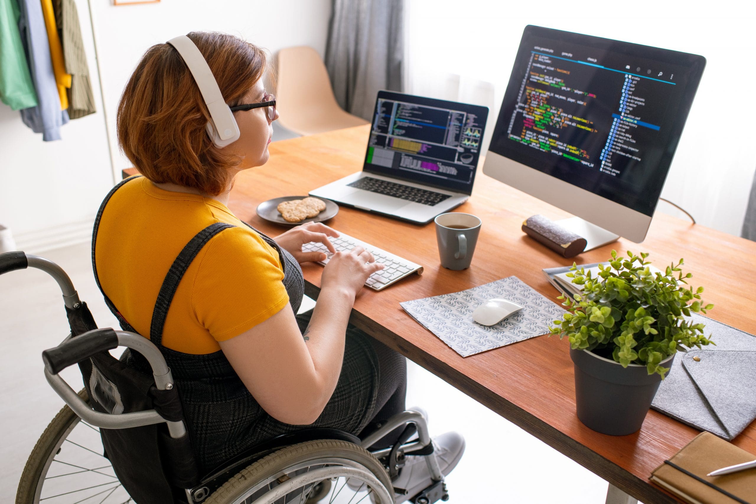 student in wheelchair studying at desk