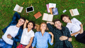 Students laying on grass