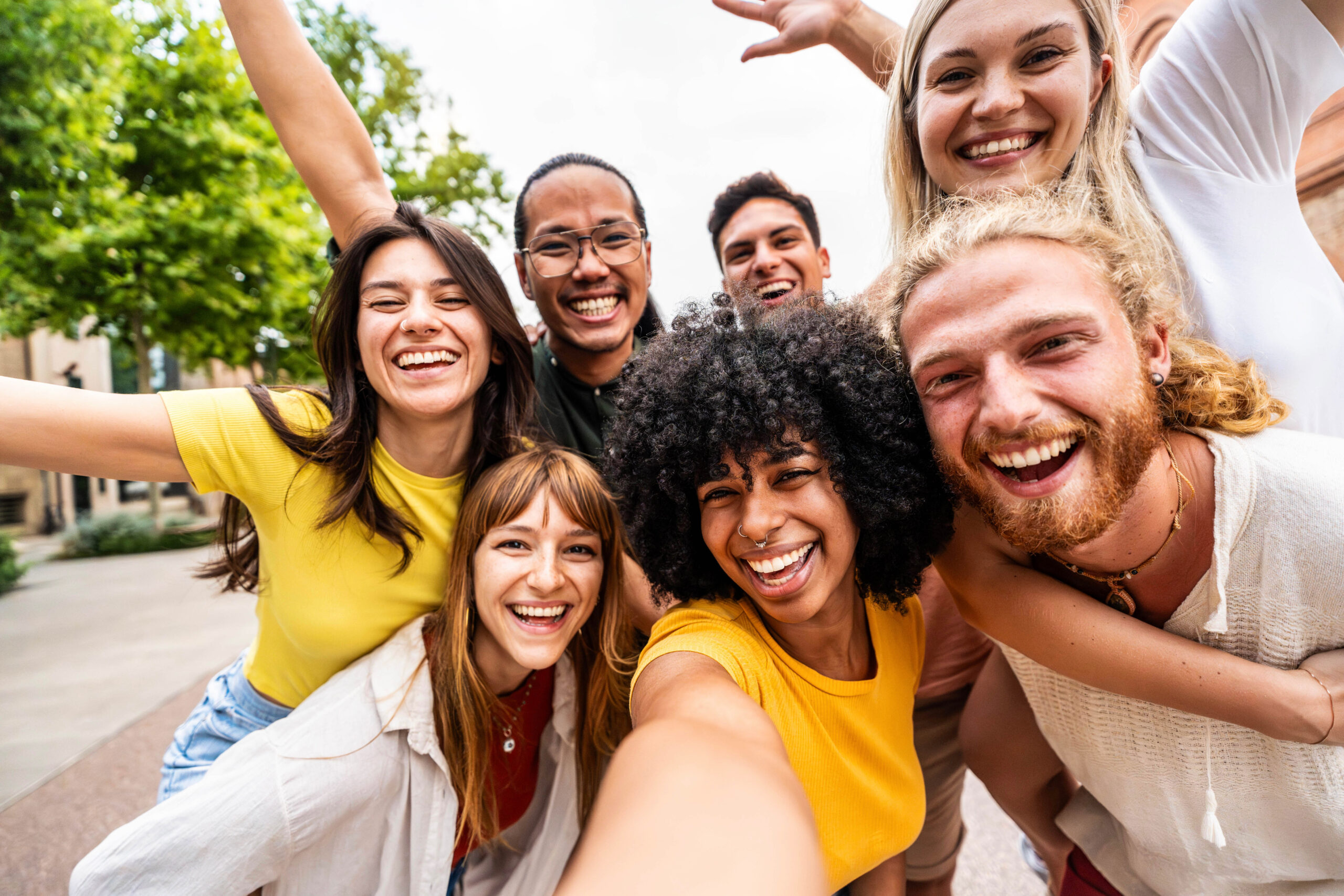 Group of smiling students taking a selfie together, enjoying student life in Greater Manchester student accommodation.