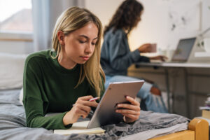 Student researching Clearing options after not getting their first choice university, studying in their Orlando Village room